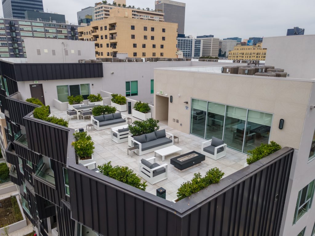 Modern infill development rooftop terrace with outdoor lounge and city views.