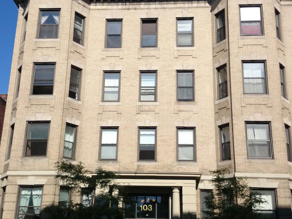 Historic multi-family apartment building exterior in urban neighborhood.