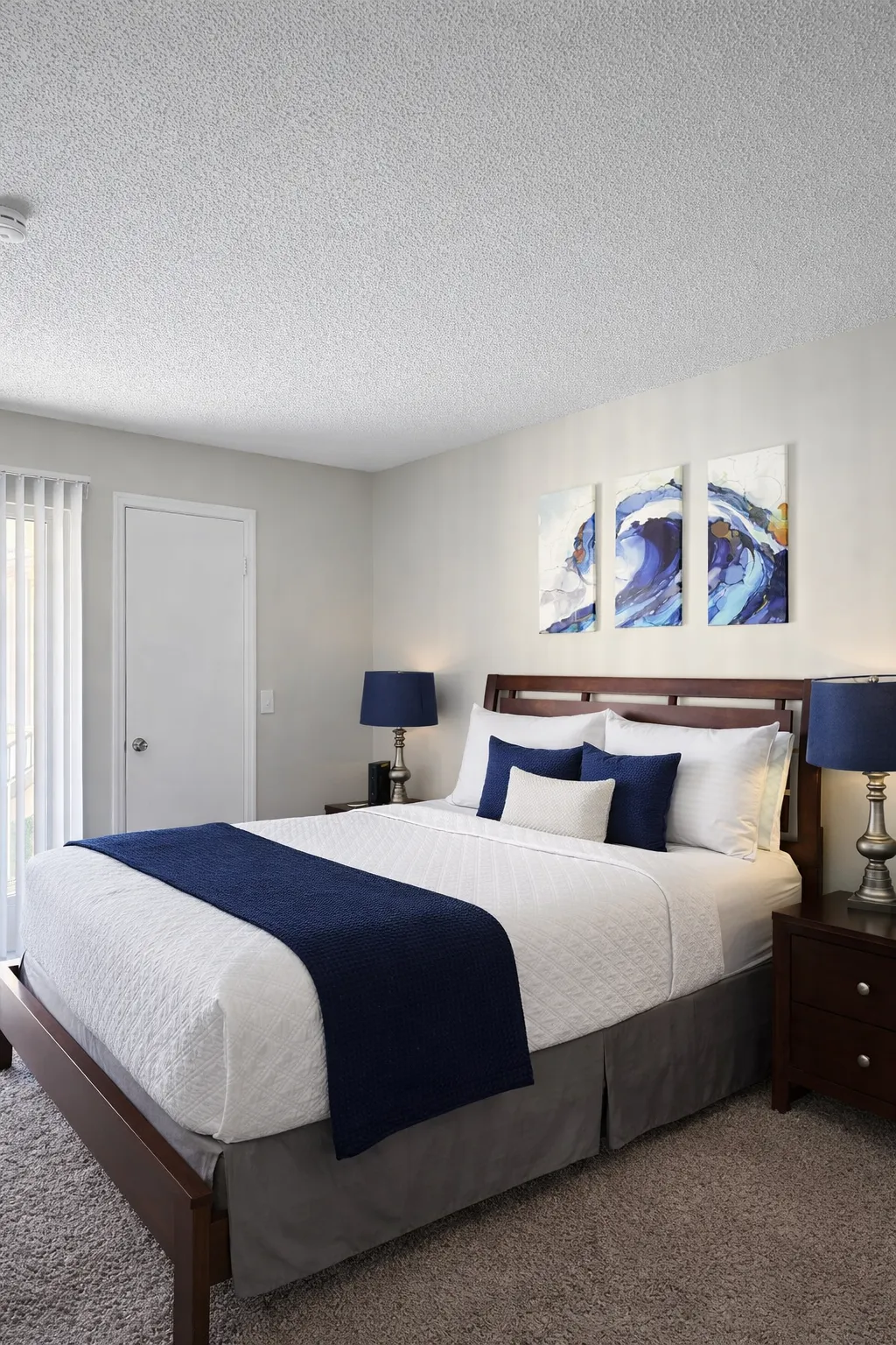 Well-appointed apartment bedroom with neutral finishes, natural light, and modern furnishings, representing multifamily residential investment opportunities.