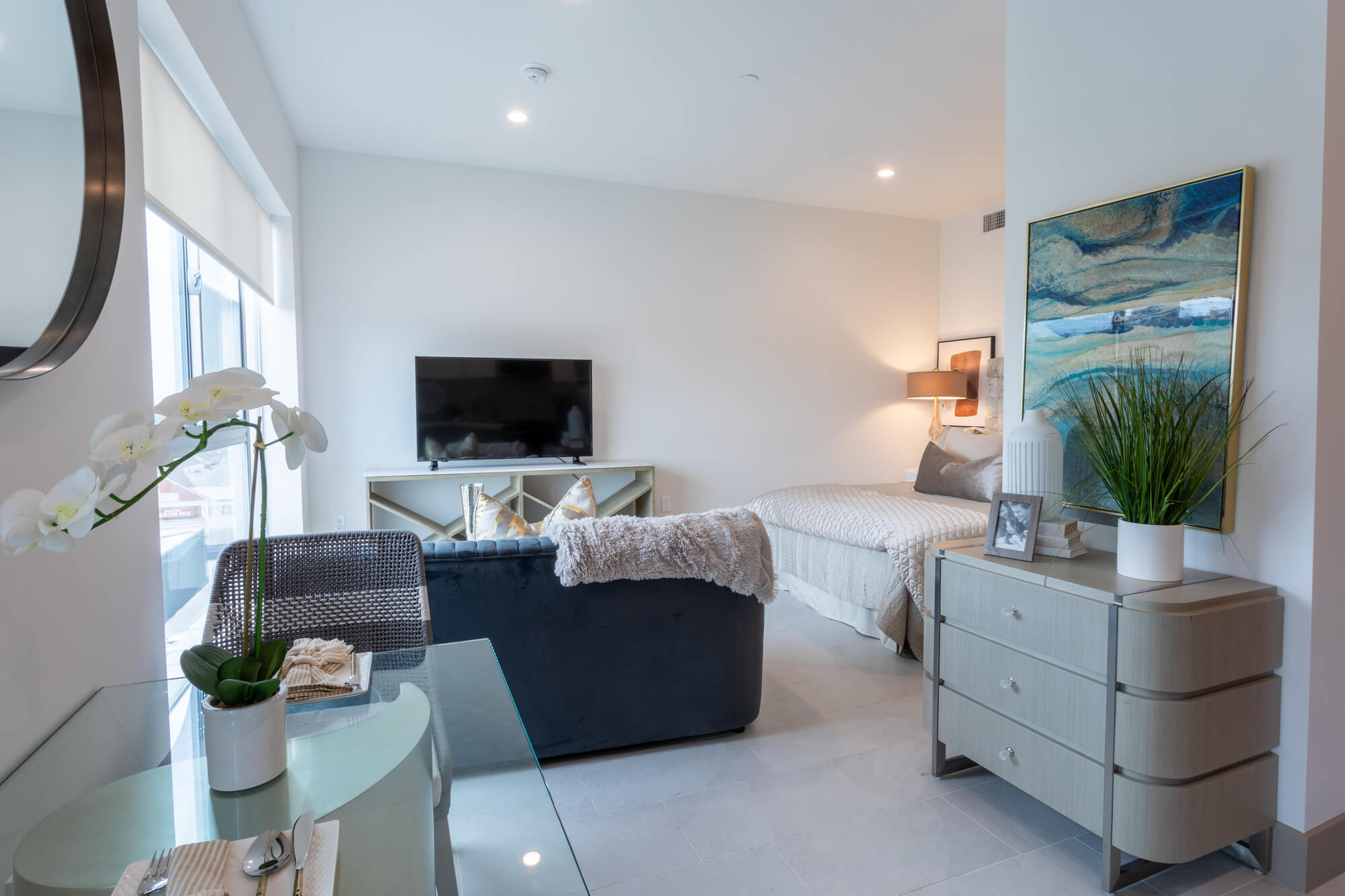 Bright apartment living area with modern furnishings, large windows, and a comfortable open-concept design.