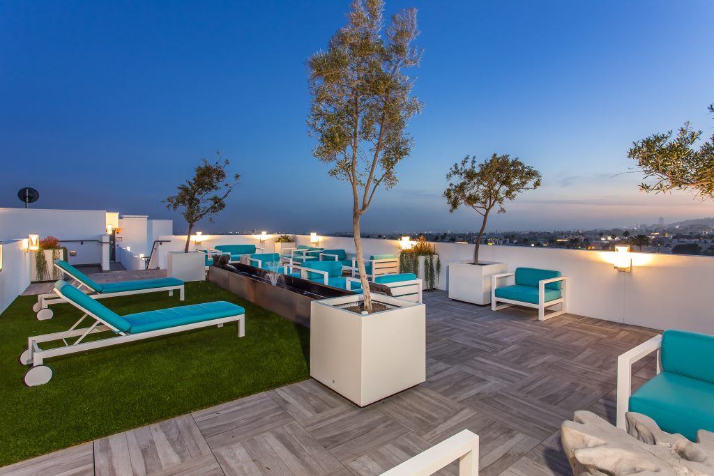 Luxury rooftop amenity deck with lounge seating and outdoor entertainment space.