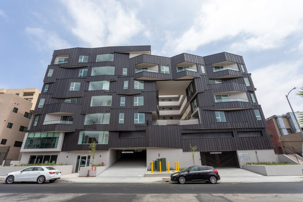Contemporary multifamily apartment building with modern angular architectural design.