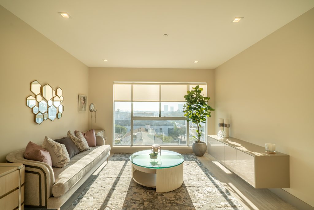 Bright modern apartment interior with minimalist living room and natural sunlight.