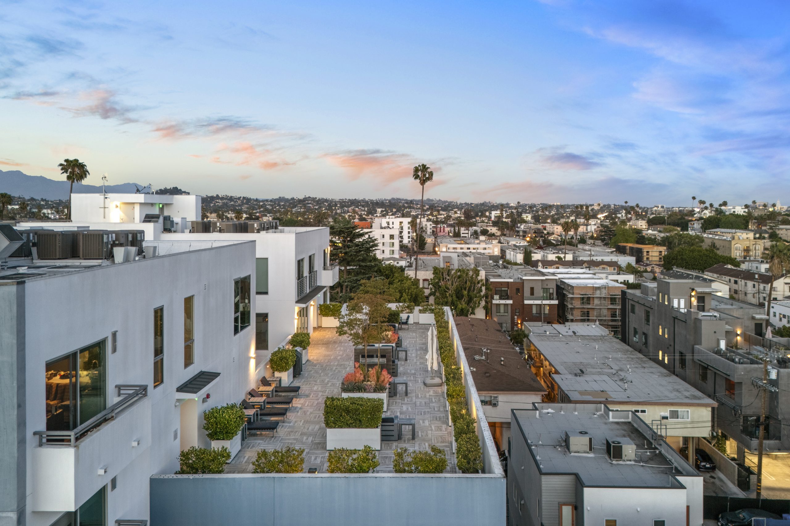Contemporary multi-family residential development with landscaped courtyard and city views.