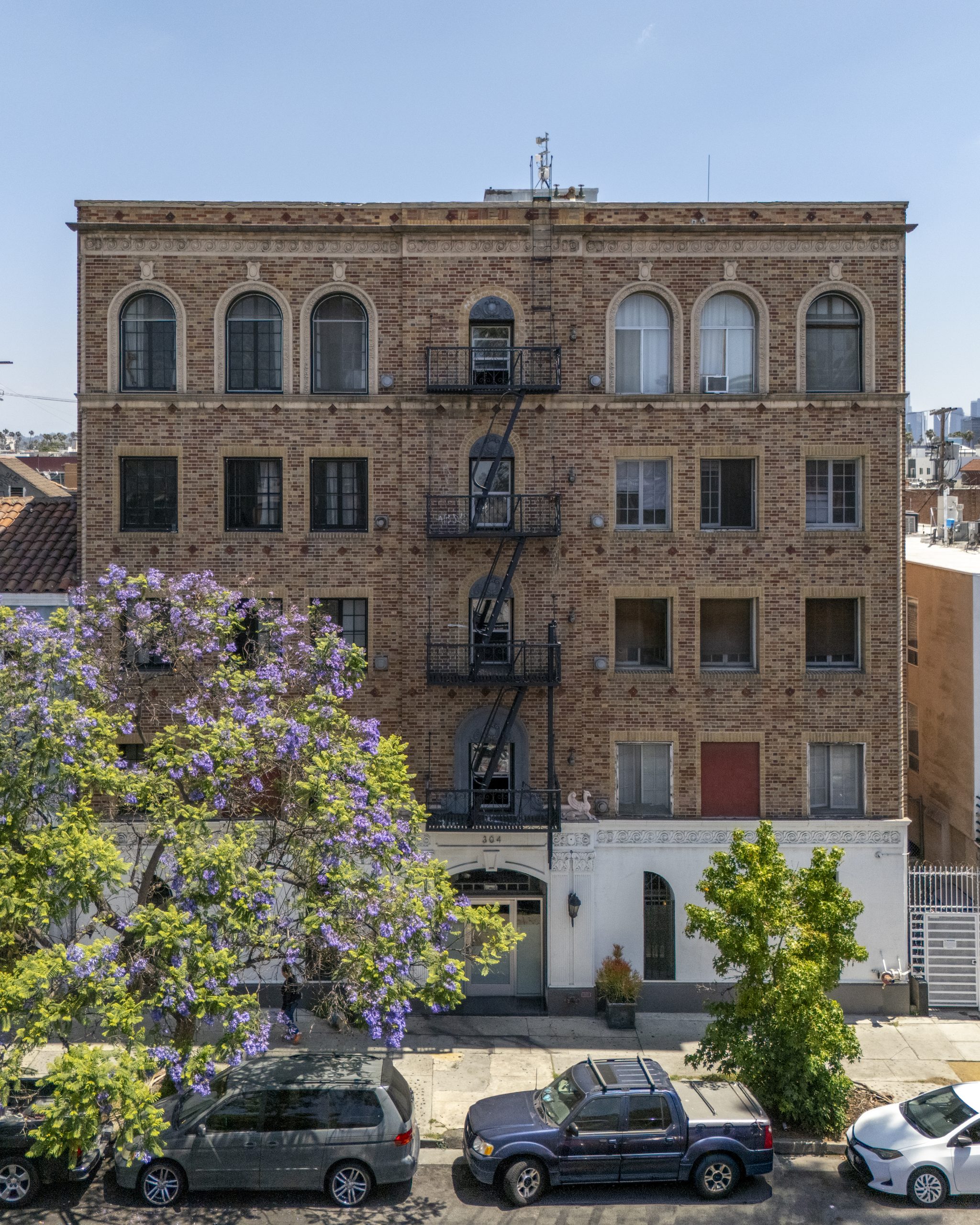 Historic brick apartment building exterior in urban neighborhood with classic architecture.